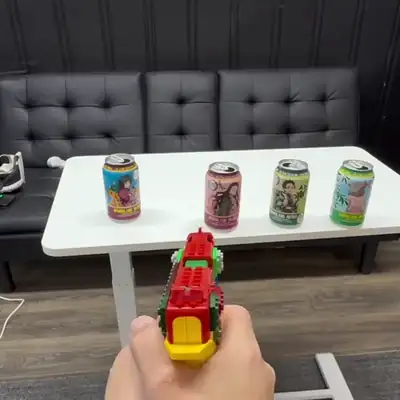 The Brick Blaster is aimed at cans on a table and fired